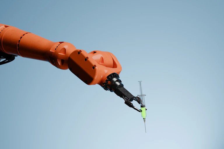 Orange robotic arm holding a syringe filled with neon green fluid between its claws