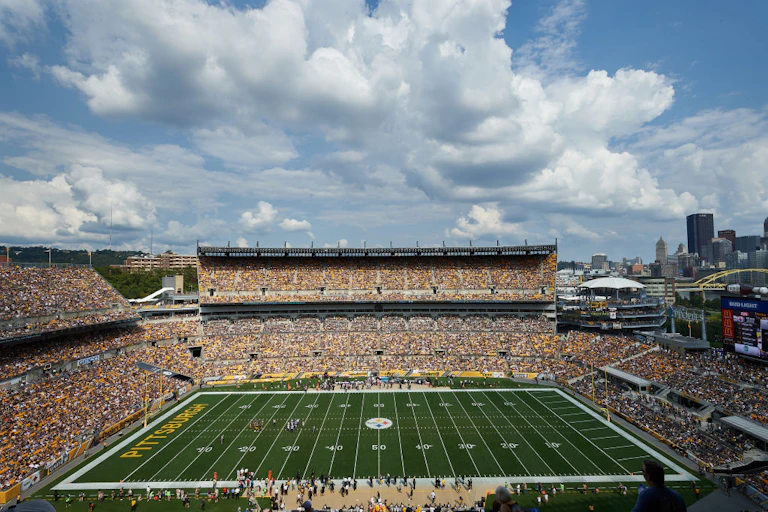 Football stadium with city skyline in the background.