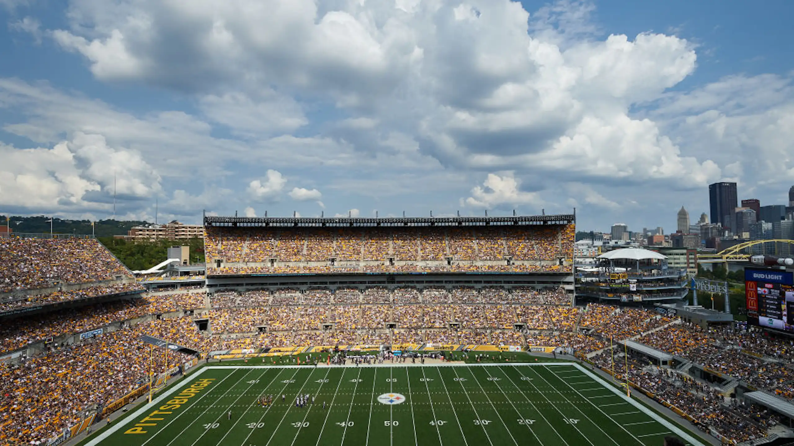 Football stadium with city skyline in the background.