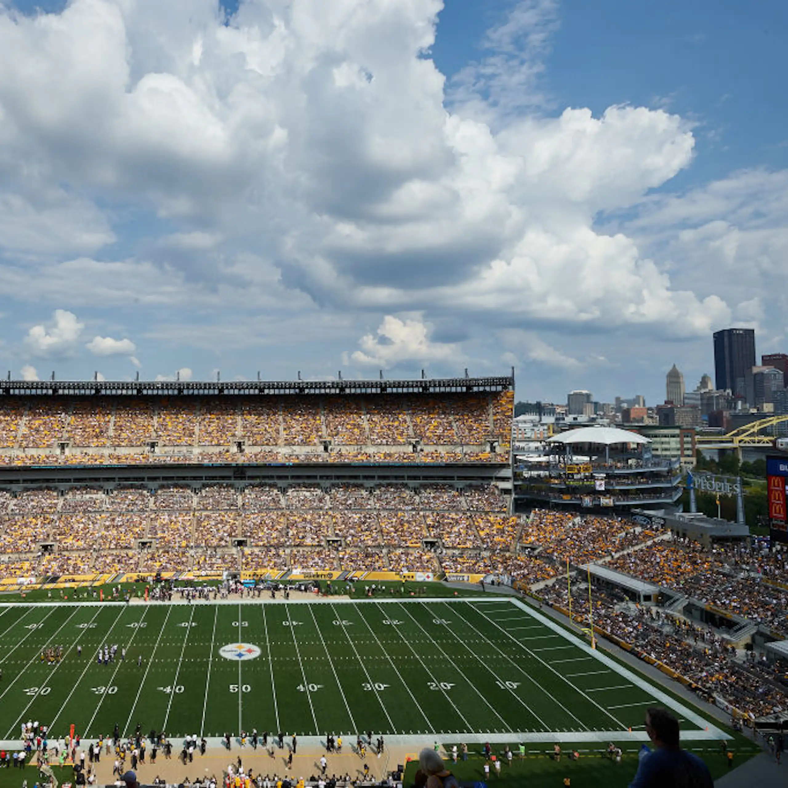 Football stadium with city skyline in the background.