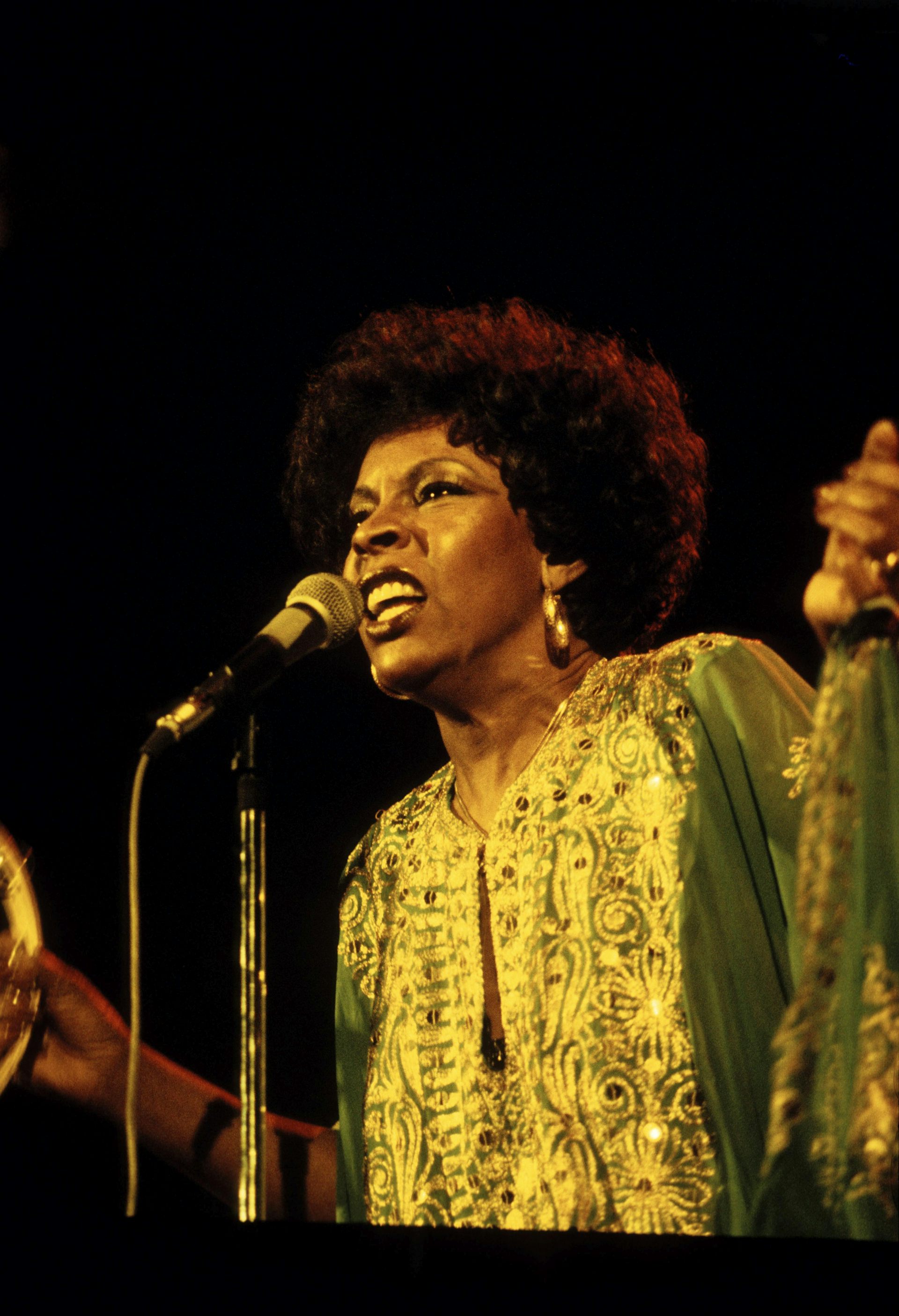 Woman singing into microphone.