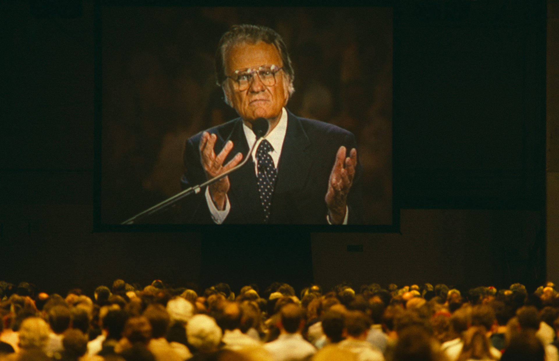 Graham projected on a large screen in front of a crowd