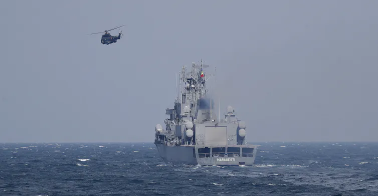 A Romanian naval vessel and helicopter take part in a Nato drill in the Black Sea.