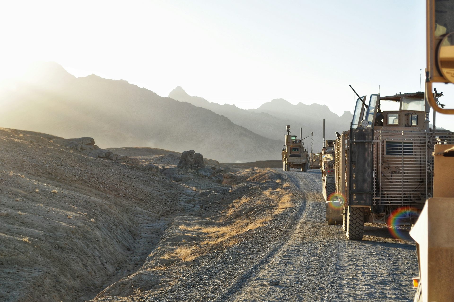 A convoy of armoured vehicles patrol a mountainous area of Afghanistan.
