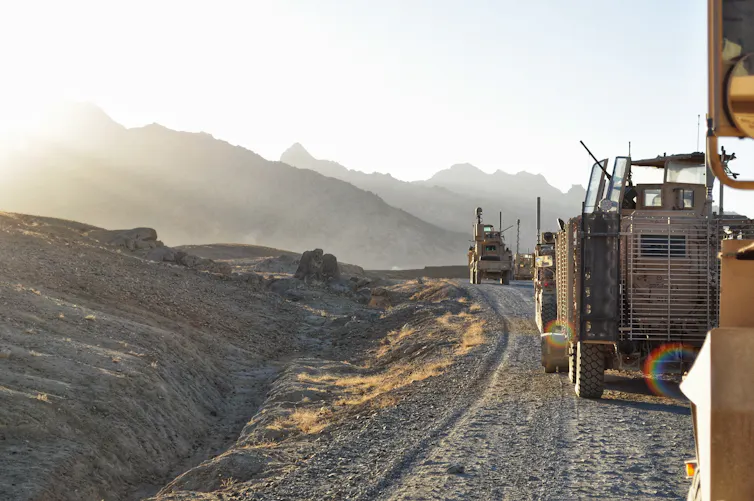 A convoy of armoured vehicles patrol a mountainous area of Afghanistan.