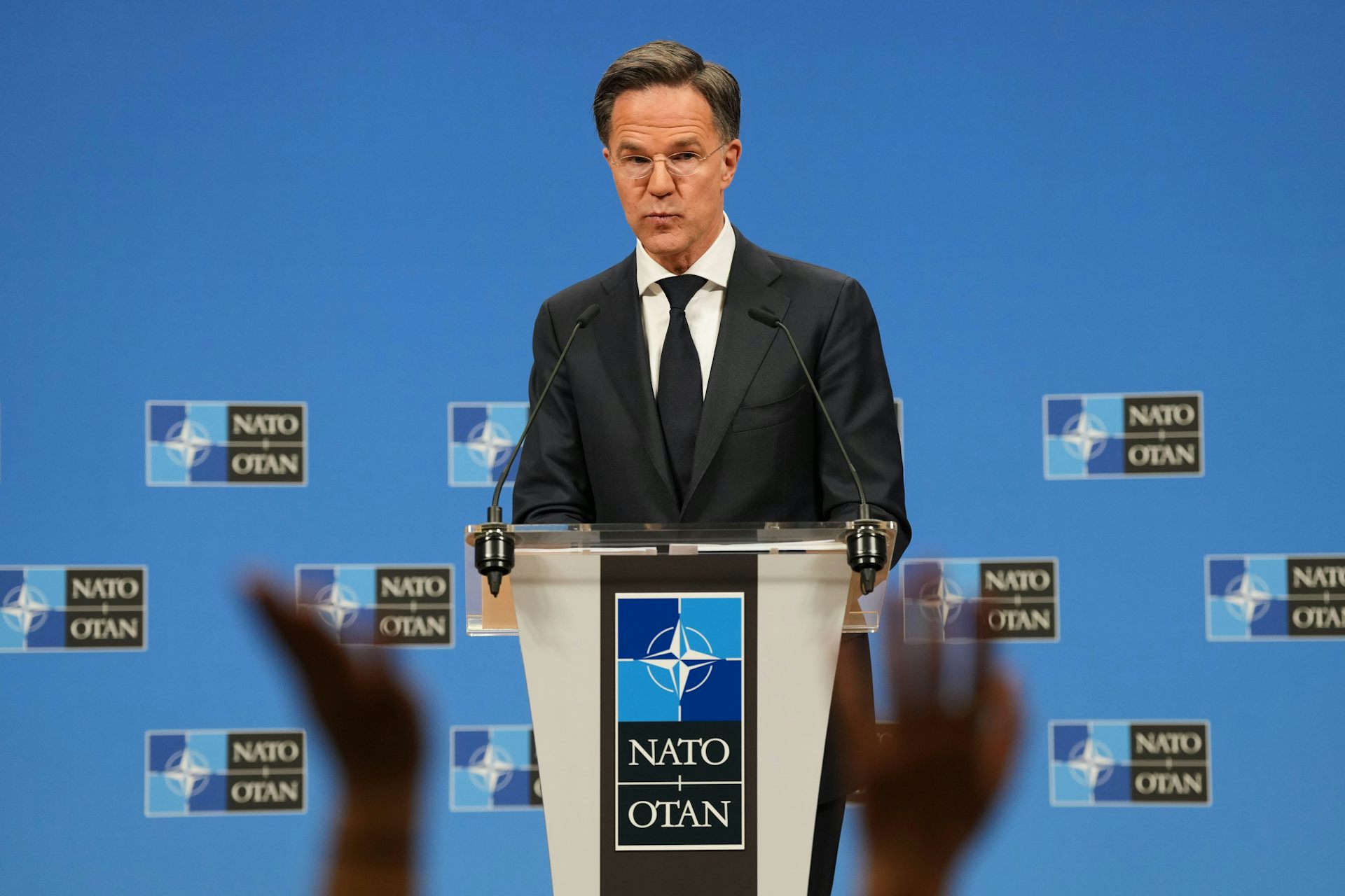 Nato secretary-general Mark Rutte takes questions at a podium.