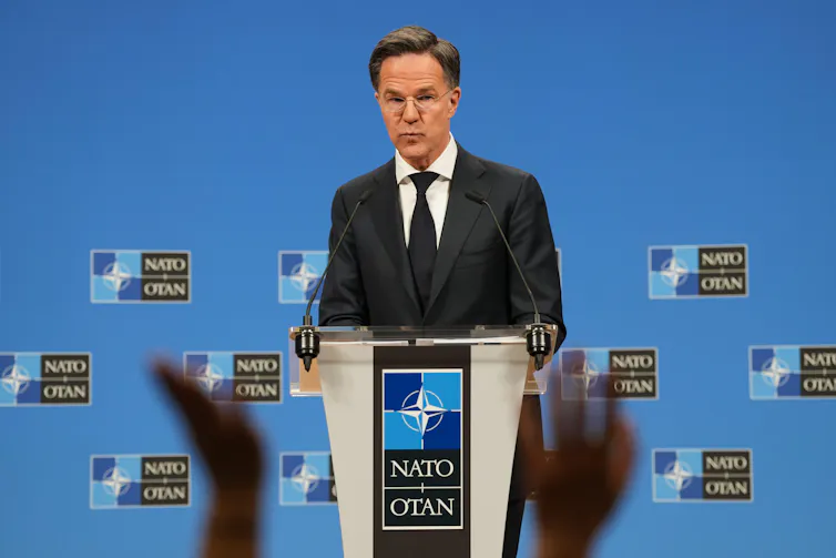 Nato secretary-general Mark Rutte takes questions at a podium.