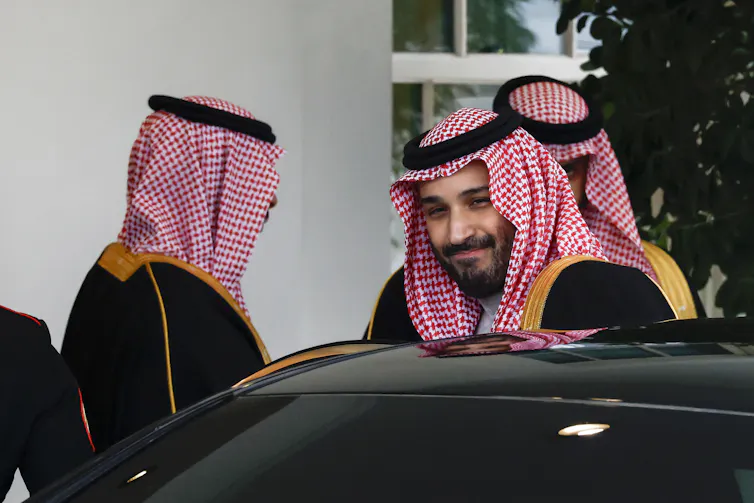 Mohammed bin Salman gets into a car after leaving the White House.