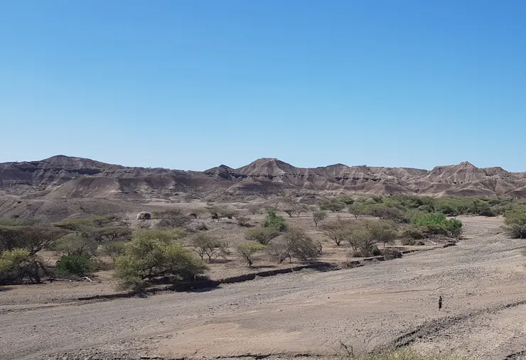 A dry valley landscape with layers in the rock.