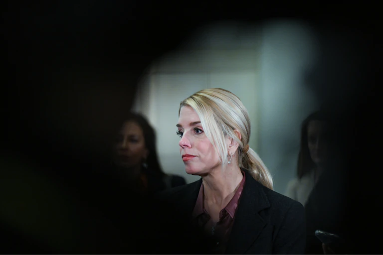 A woman in a building stares into the distance.
