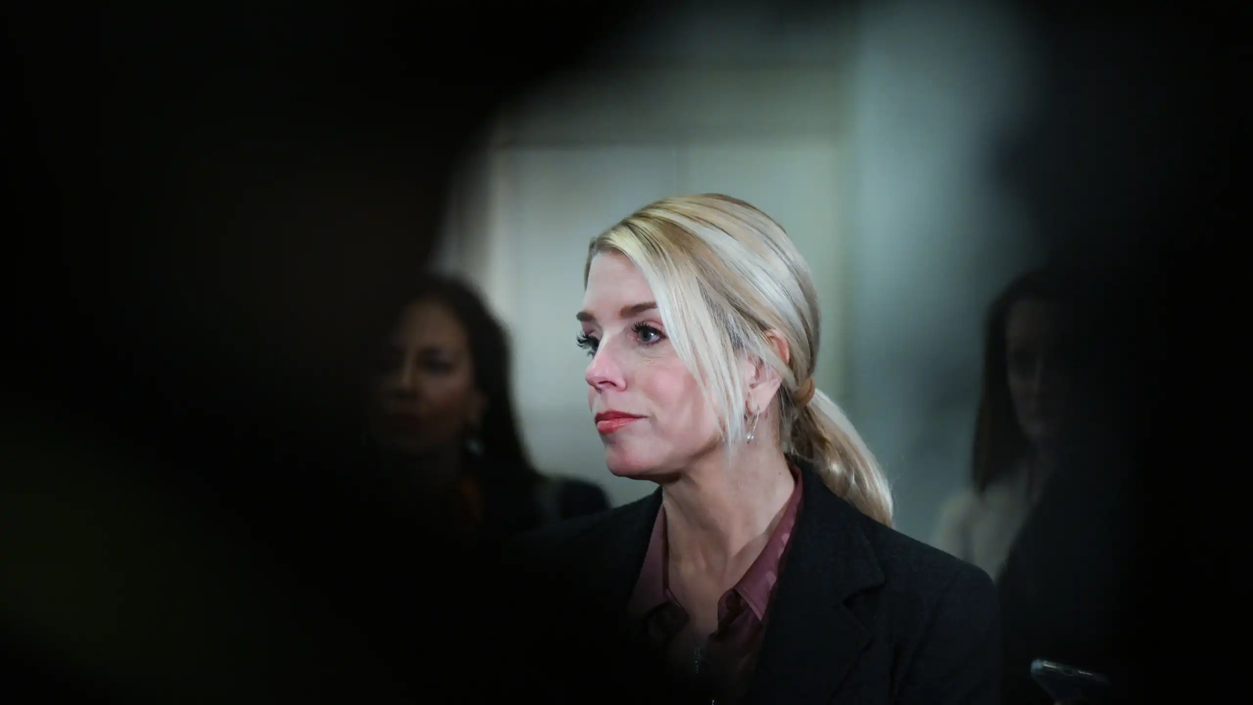 A woman in a building stares into the distance.