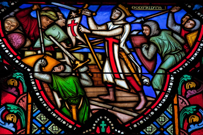 Soldiers wielding swords are depicted alongside a crucifix in a stained-glass window.