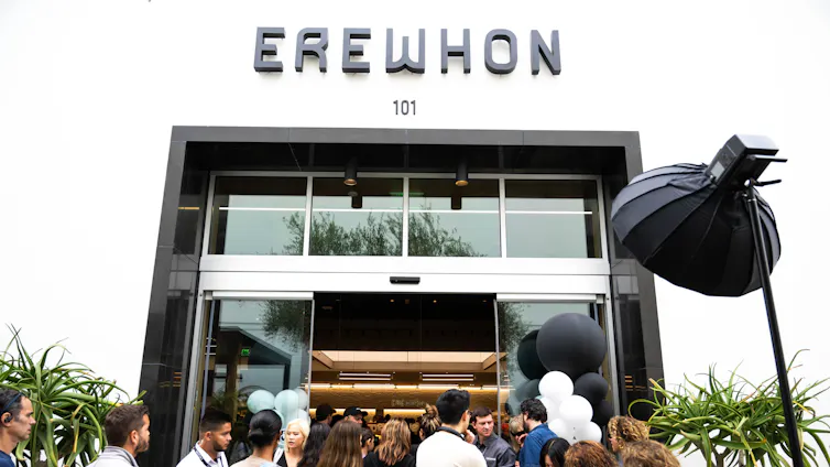Shoppers enter and exit the crowded high-end grocery store Erewhon in Pasadena, Calif.