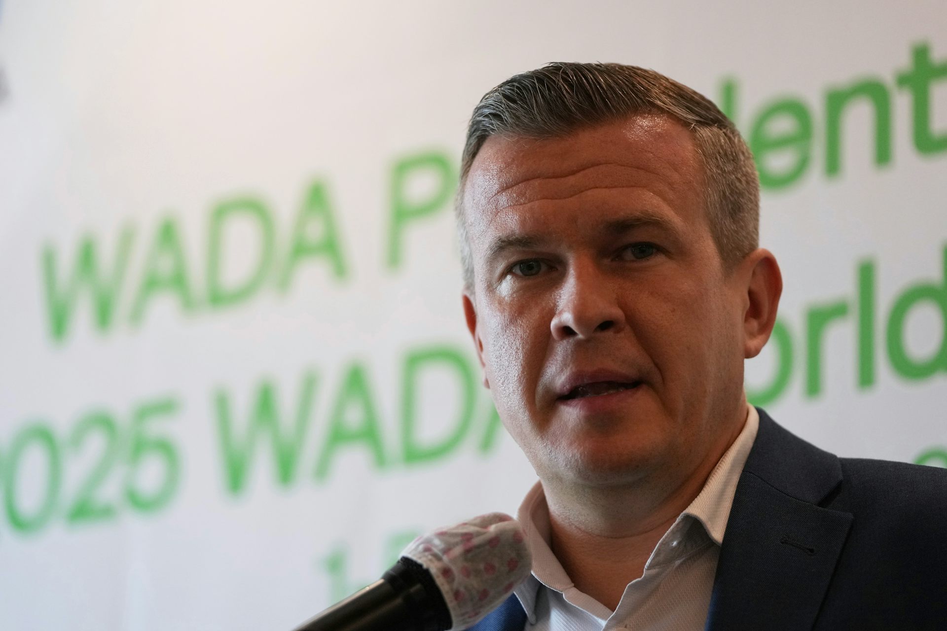 A middle-aged man speaking into a microphone