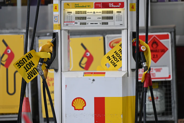 A petrol station pump is seen with a 'pump not in use' sign attached
