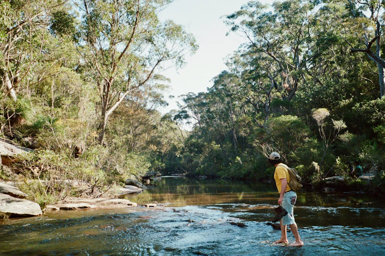 man paddling in a creek