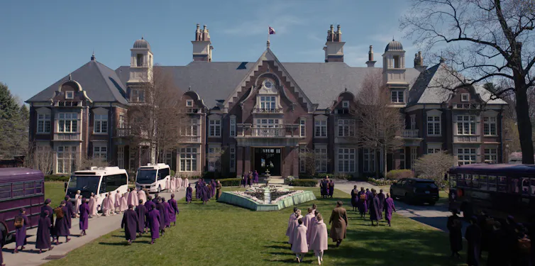 Women stood outside a grand house