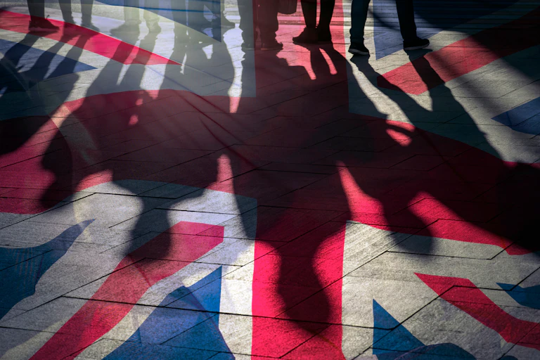 Shadows of people cast onto a UK flag