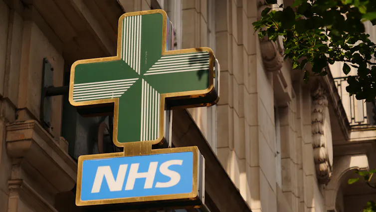 An NHS sign outside of a a chemist's.
