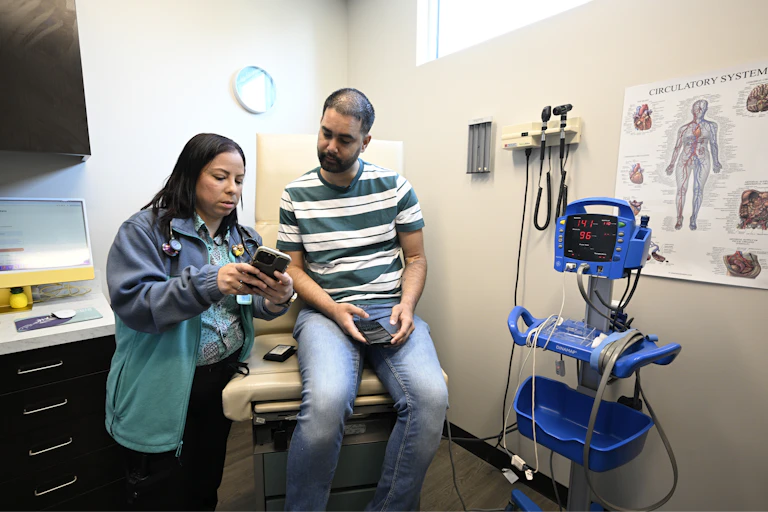 Clinician talking to patient in a clinical exam room