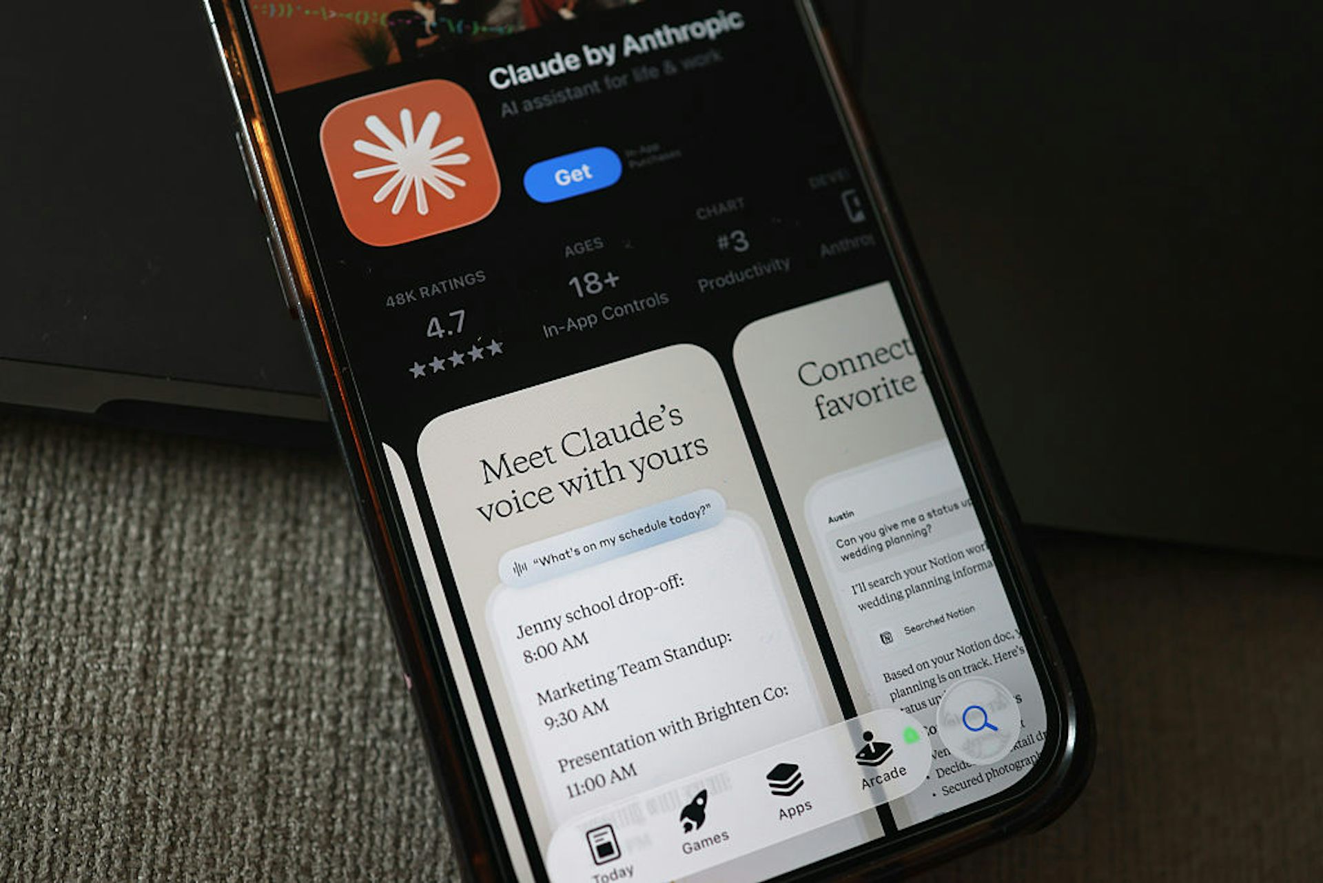 The Claude AI app is seen in the app store on a smartphone with the promotional text 'Meet Claude's voice with yours.'