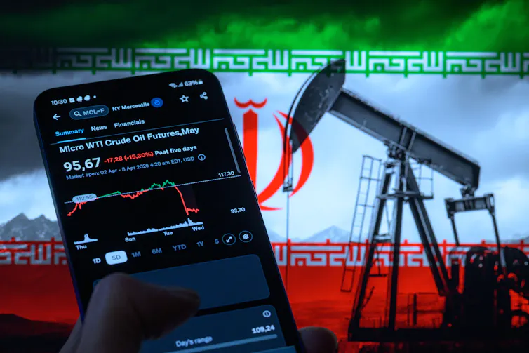 COmposite image of a smartphone displaying a drop in oil prices against a background of an Iranian flag and an oil derrick.