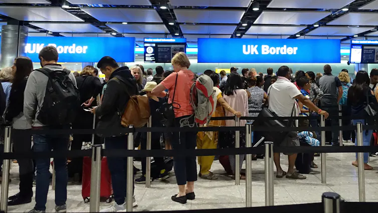 Travellers in a queue at the UK border