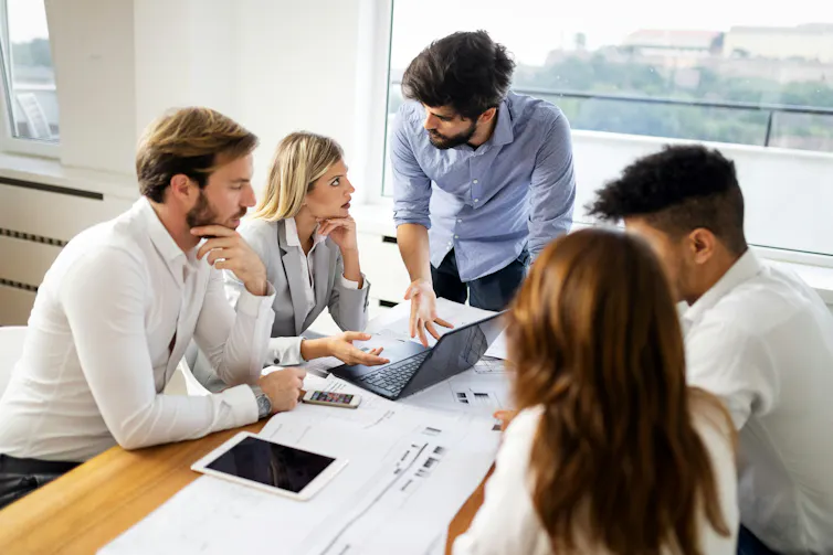 A group of people meeting around a table