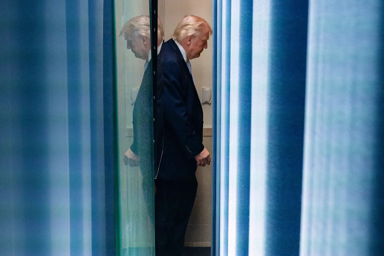 The side profile of Donald Trump as he walks away from the media room in the White House