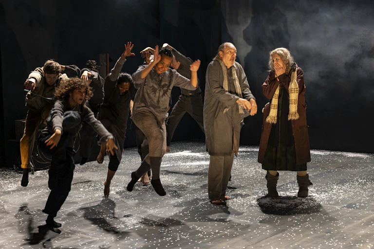 Production image: the cast dance on stage.