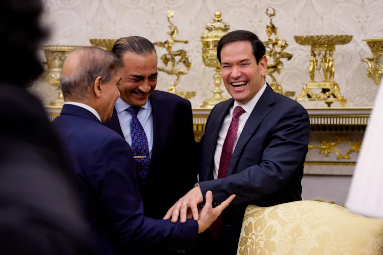 The Pakistani Prime Minister, Shehbaz Sharif, shakes hands with US Secretary of State, Marco Rubio, as Field Marshal Asim Munir watches on.