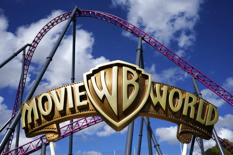 A roller coaster behind the Movie World sign