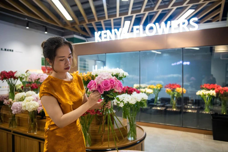 Woman makes a bouquet of flowers