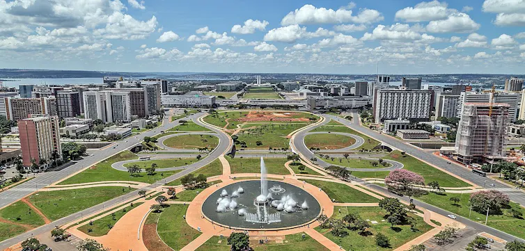 A vast memorial park with buildings on either side.