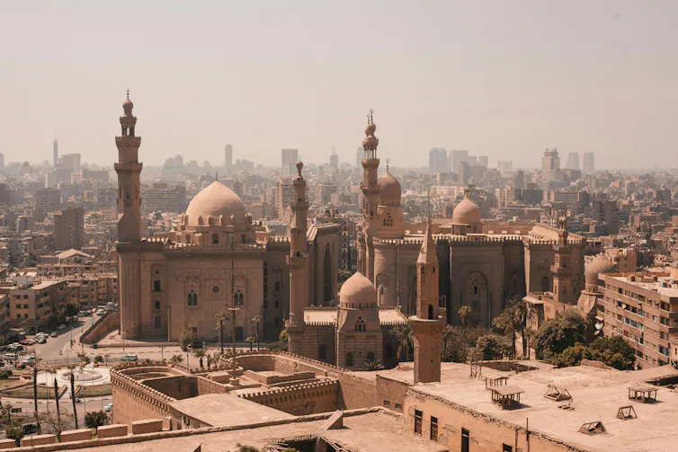A grand mosque in the centre of a vast city.