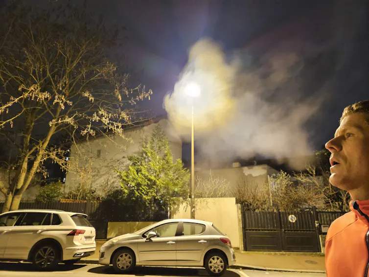 How are raindrops shaped? 2 a man blowing in front of a street lamp and creating a cloud of condensation