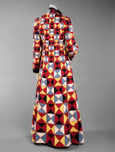 A mannequin wearing a brightly coloured geometric patterned coat.