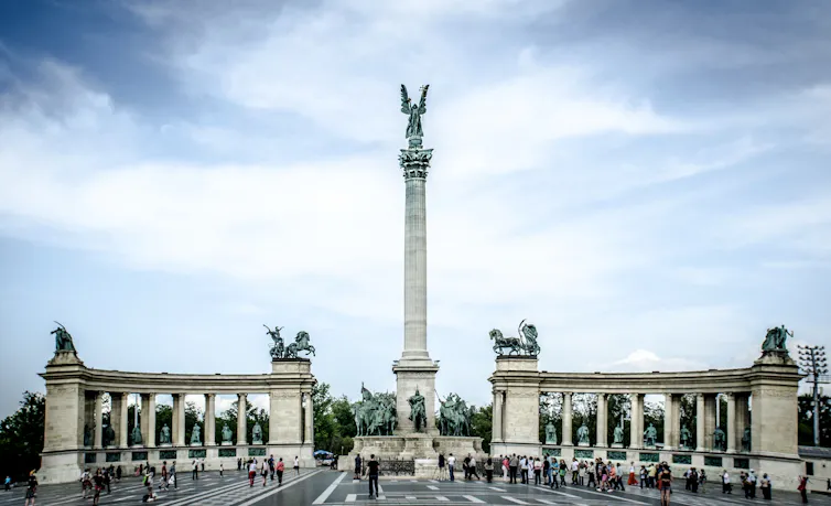 The monument on Budapest's Heroes' Square under a pale sky.