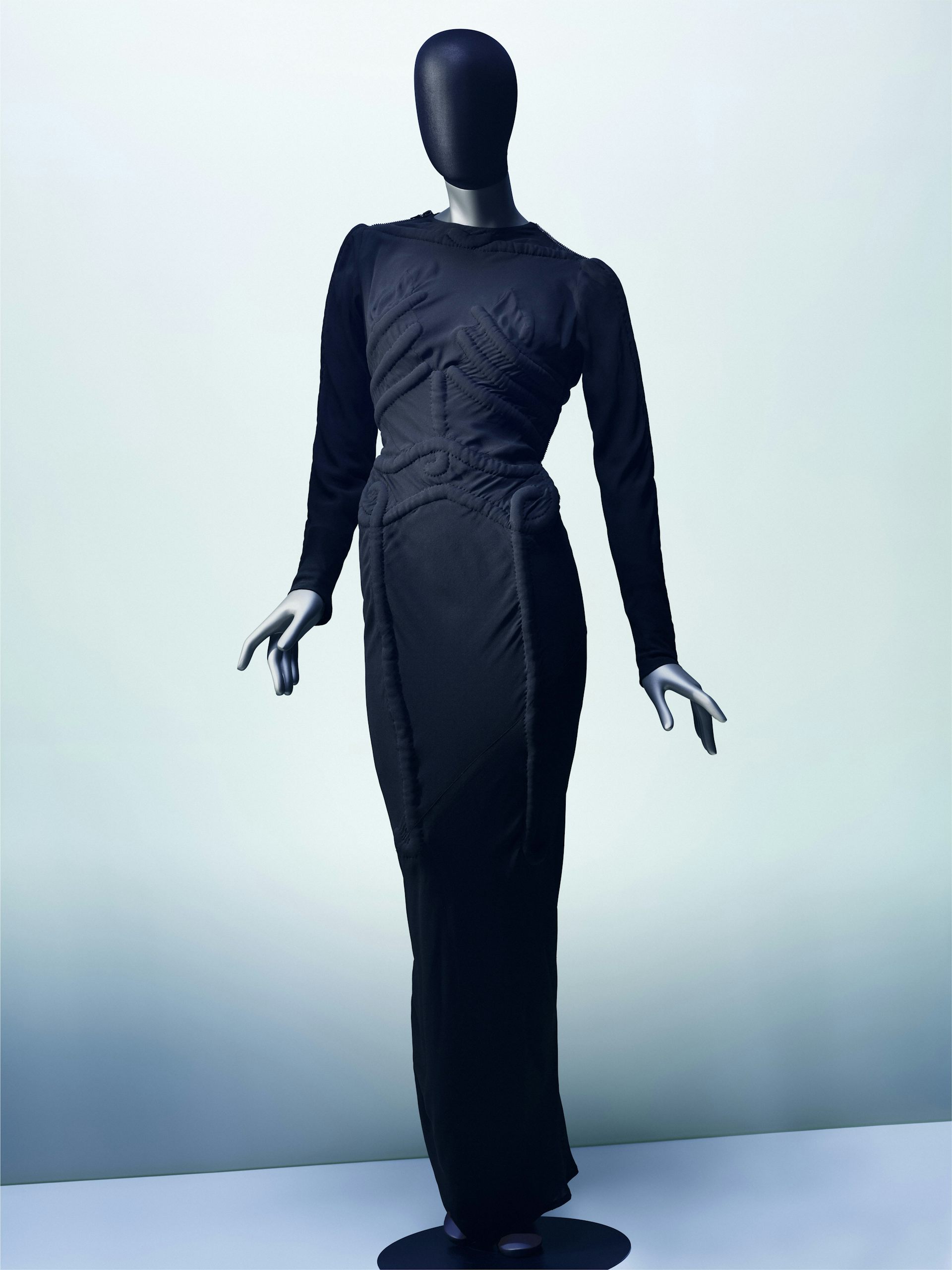 A black close fitting dress with the outline of a ribcage on it.