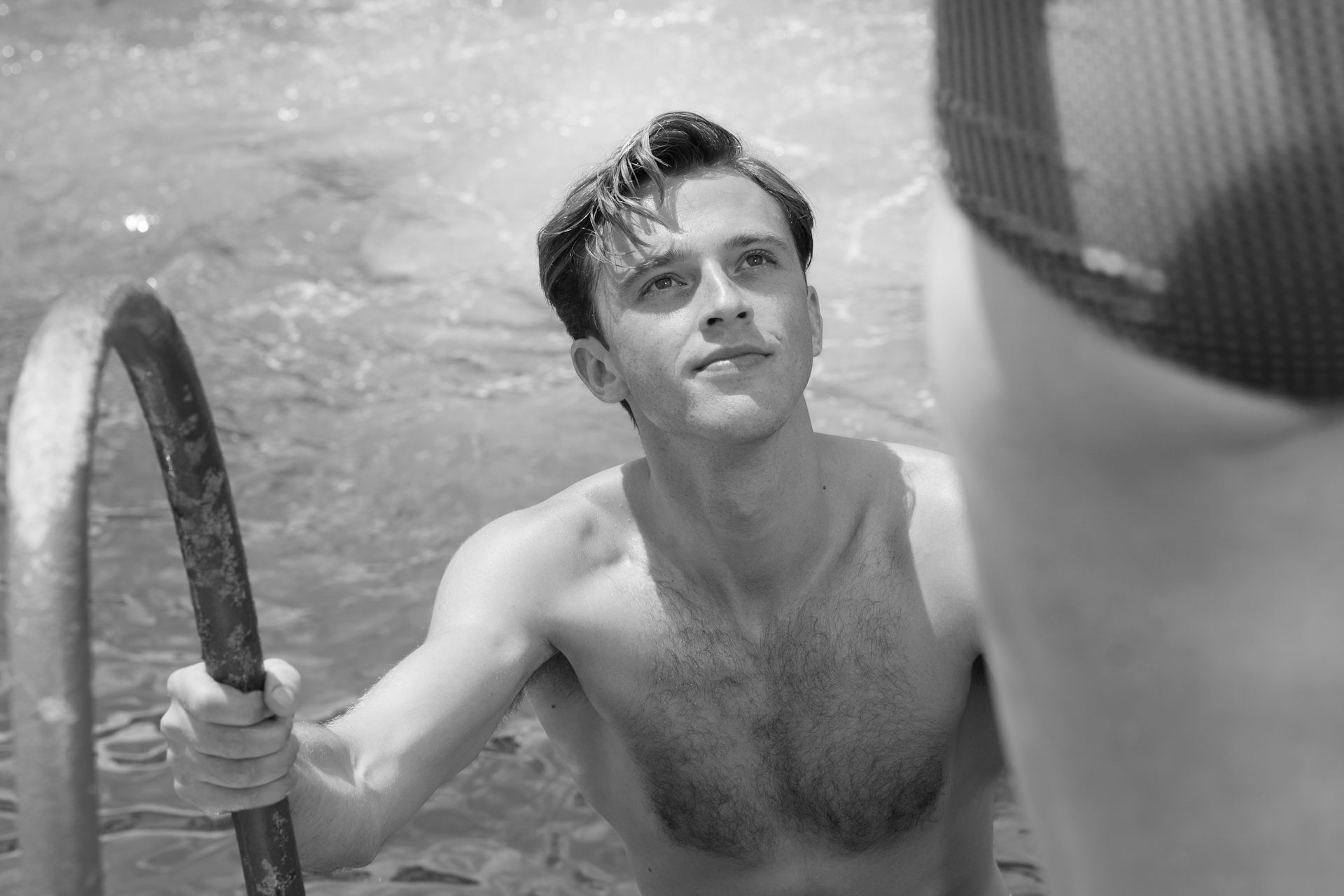 A boy climbing out of a pool