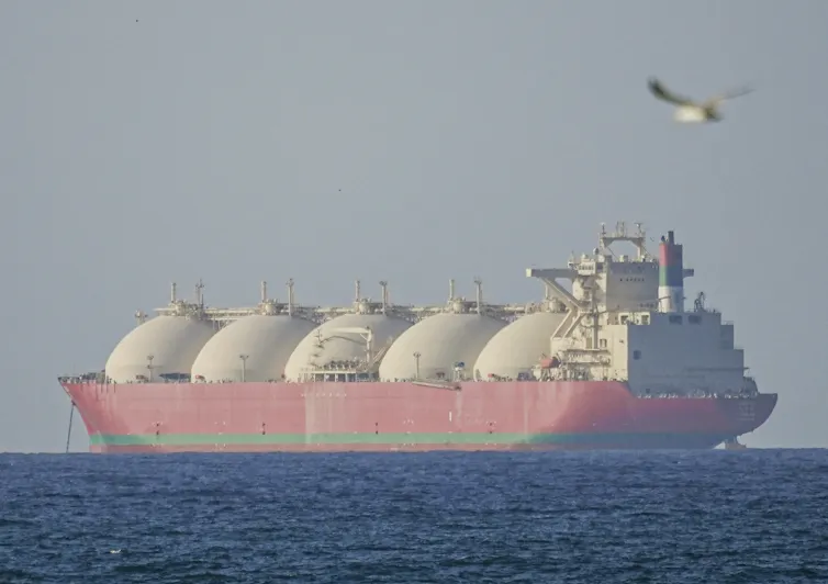 A large ship passes through a strait.