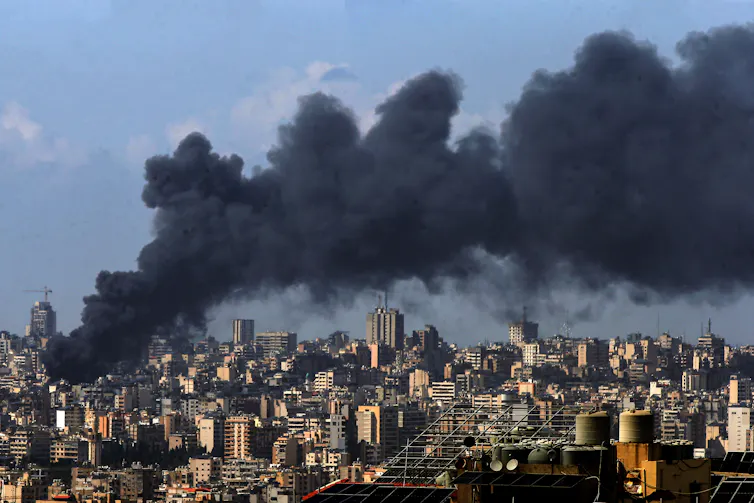 Smoke rises from a city center.
