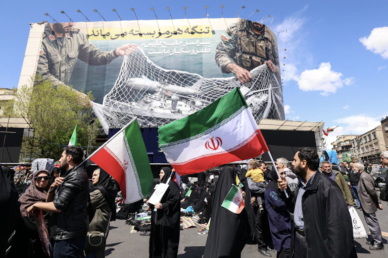 People in a city square hold flags.