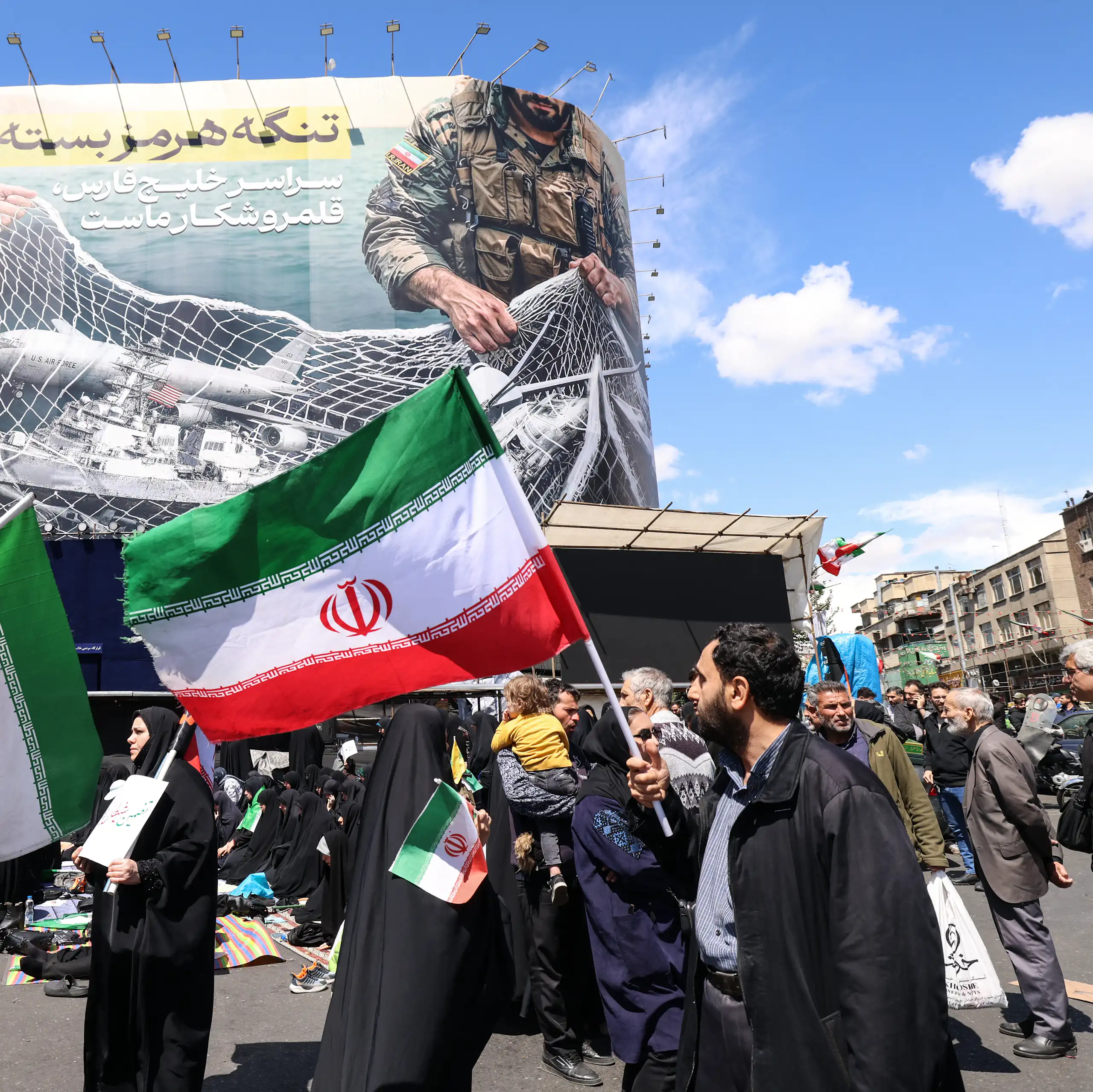 People in a city square hold flags.