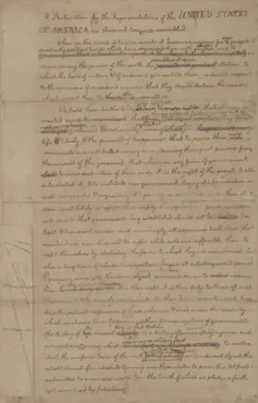A faded piece of paper with handwriting on it, including many crossed-out words and notes.