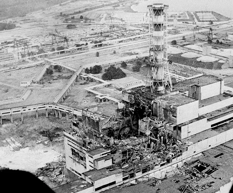 a black and white photo of a heavily damaged power plant building