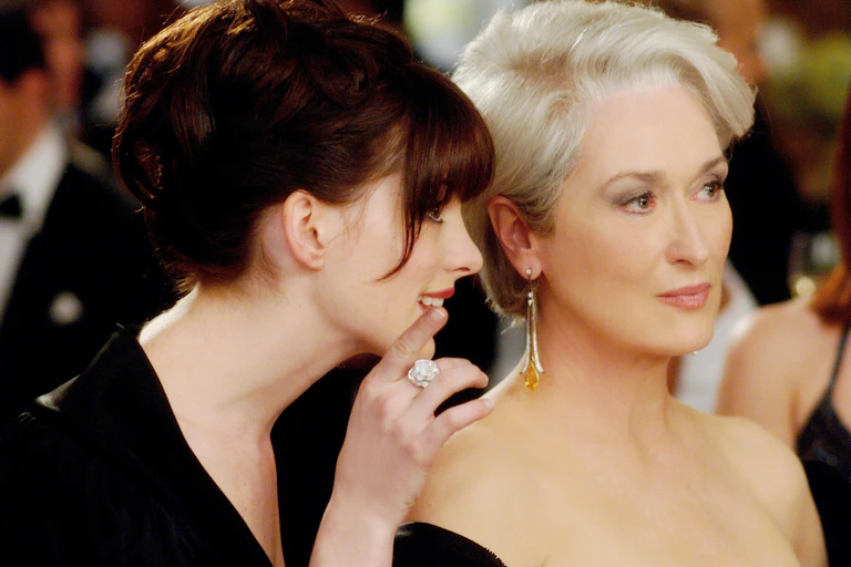 Film still: Anne Hathaway and Meryl Streep at a party.