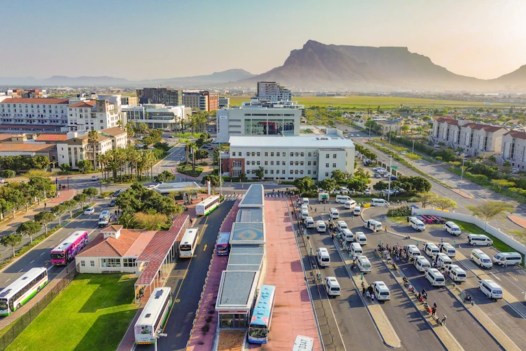 Illustration of a taxi and bus rank with a mountain in the background