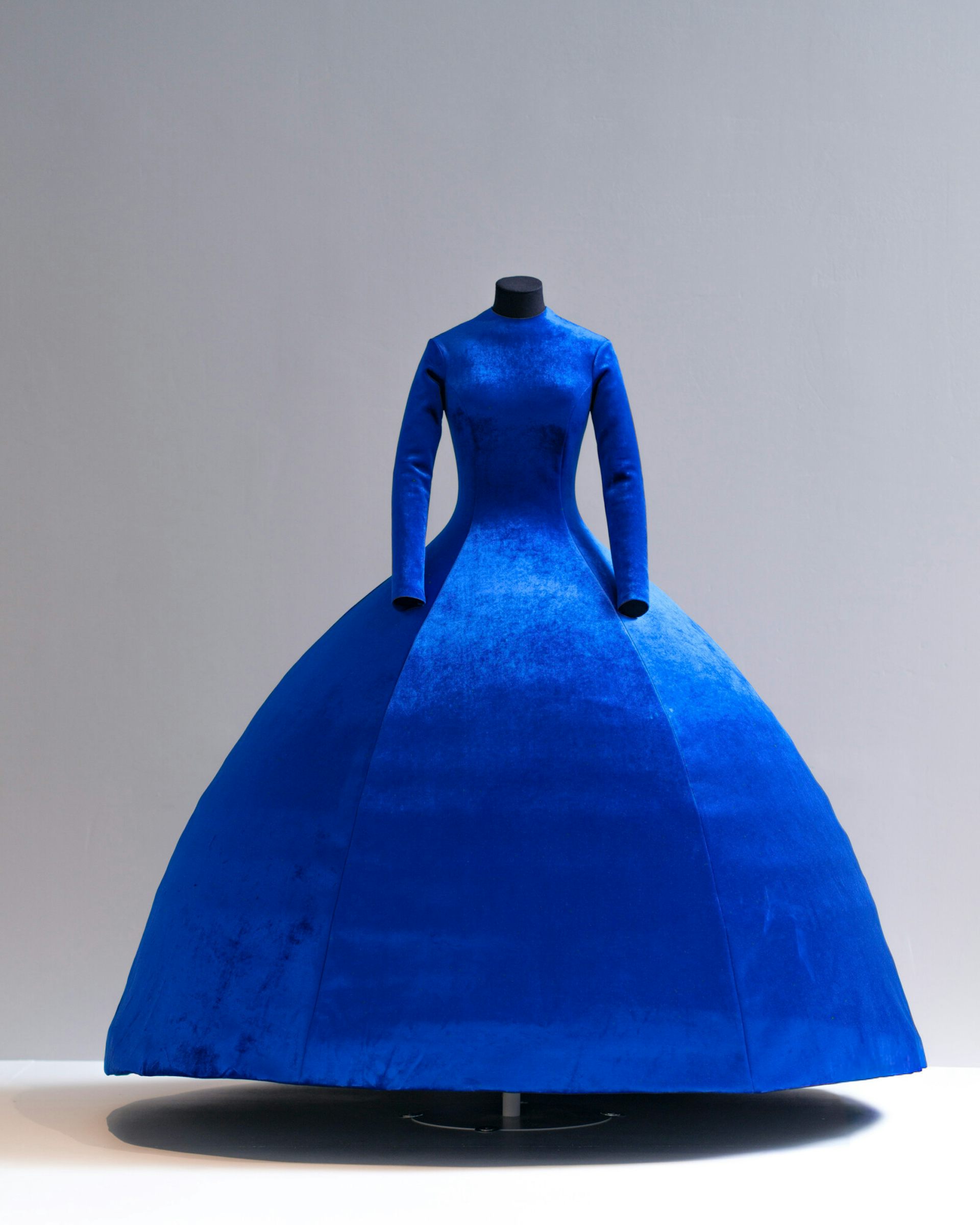 A voluminous blue dress on a mannequin.