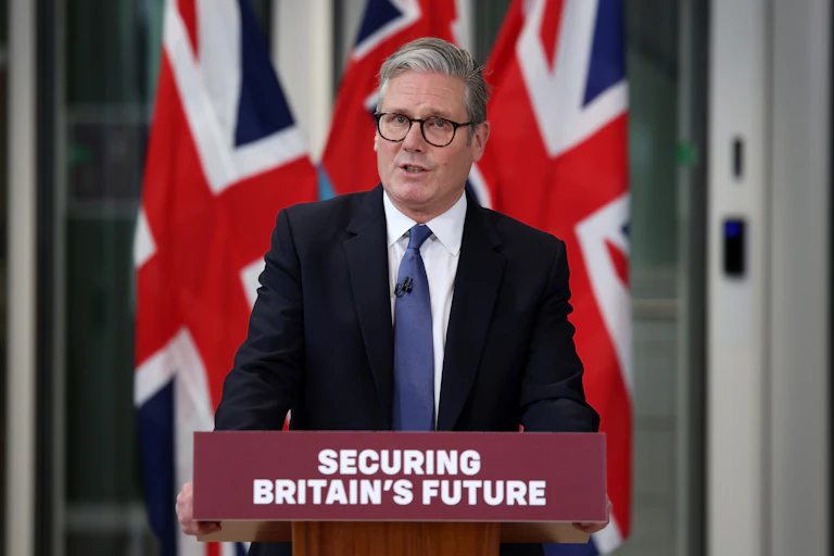 Starmer speaking at a podium that reads 'securing Britain's future'